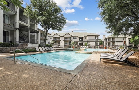 a resort style pool and lounge chairs at Jefferson Creek in Irving, TX